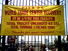 [photo of banner:
"Pier 25 / World Trade Center Recovery /
As of 5/8/02 This facility: /
Total trucks unloaded 62,581 /
Total tonnage 1,118,460 /
Thanks for your support"